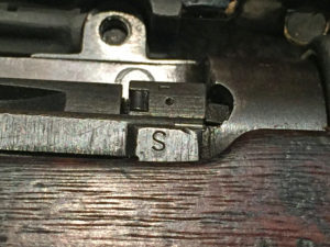 "S" mark on a No. 4 MK. I (T) indicating that the iron sights had been checked before the rifle was sent to Holland and Holland for sniper conversion.