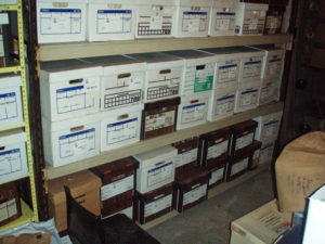 Artifact storage iising Banker Boxes n the Fan Room. "Like with like" i.e. webbing together, shoes together etc.