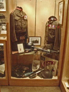 Case 7 upper - Victoria Cross Winners - LtCol Cec Metritt VC on left (one of his part-WWII BD blouses) and on right replica of Smokey Smith VC BD blouse. Decorations and medals are replicas or generic.