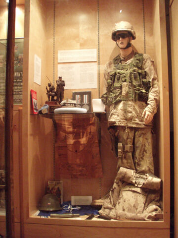 Captain Trevor Greene's Afghanistan worn uniform. He was hit on the head with an axe. Boots, holster, glasses and helmet are from others. Seaforth Museum - Recent wars case featuring Captain Trevor Greene's Afghanistan worn uniform. July 2011