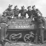 Group of "D" Company, Seaforth of C. personnel posing with Universal Carrier, 7 May 1945 in Holland. Another photo taken a few minutes before had VANCOUVER chalked on the side. This was rubbed out and CANADA chalked in to accommodate Seaforths who were not from Vancouver.