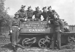 Group of "D" Company, Seaforth of C. personnel posing with Universal Carrier, 7 May 1945 in Holland. Another photo taken a few minutes before had VANCOUVER chalked on the side. This was rubbed out and CANADA chalked in to accommodate Seaforths who were not from Vancouver.