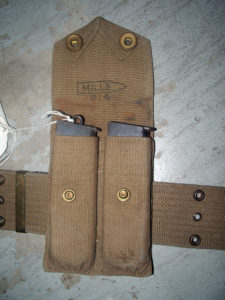 The MILLS 1914 magazine pouch with two magazines for Colt 1911 Commercial pistol, one of 5,000 purchased by Canada in 1914, serial number C13085. Shows the MILLS (inside a cartridge) . On the magazine on the right, the staple has broken off.