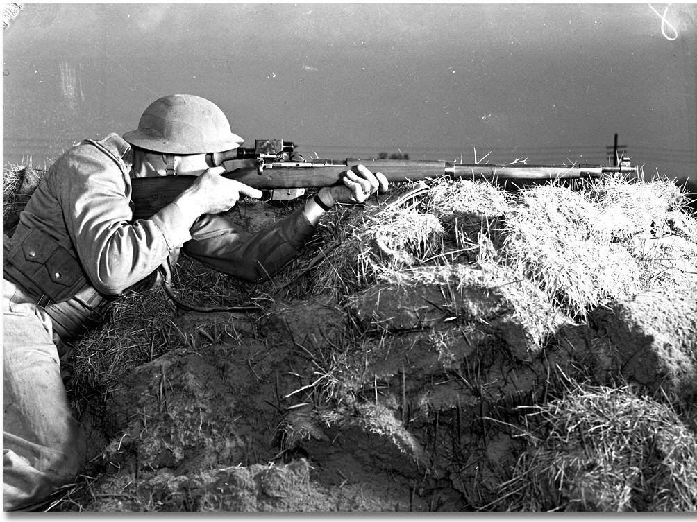 Soldier aiming a telescopically equipped rifle. (Photo credit: Archives of Ontario)