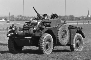 Ferret Scout Car with a helicopter hovering overhead.
