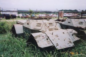 Derelict Ferret SWcout Car in a surplus yard.