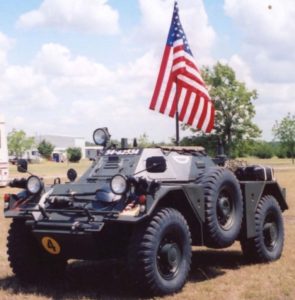 Restored Ferret Scout Car with big American flag.