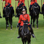 The Officer Commanding the Musical Ride gives a salute with his sword. (D7100a 247)