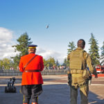 "Here comes your ride Sir!" Two RCMP members awaiting the arrival of the RCMP helicopter.