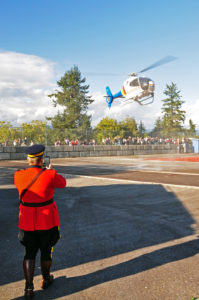 RCMP Officer photographing the landing of the RCMP helicopter at Swangard Stadium. (D90 031)
