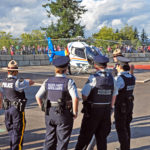 "They only issue us Auxiliaries bicycles." RCMP members looking at the RCMP helicopter.