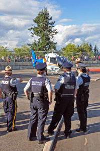 "They only issue us Auxiliaries bicycles." RCMP members looking at the RCMP helicopter.