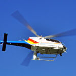 Bottom view of a plice helicopter in flight.