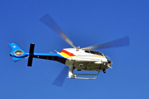 Bottom view of a plice helicopter in flight.