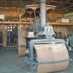 Steam roller in a museum shelter.