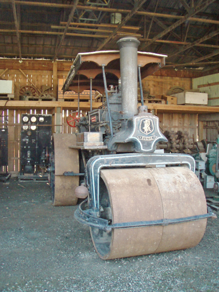 Steam roller in a museum shelter.