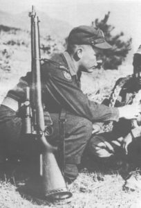 Canadian soldier with sniper rifle over his shoulder.