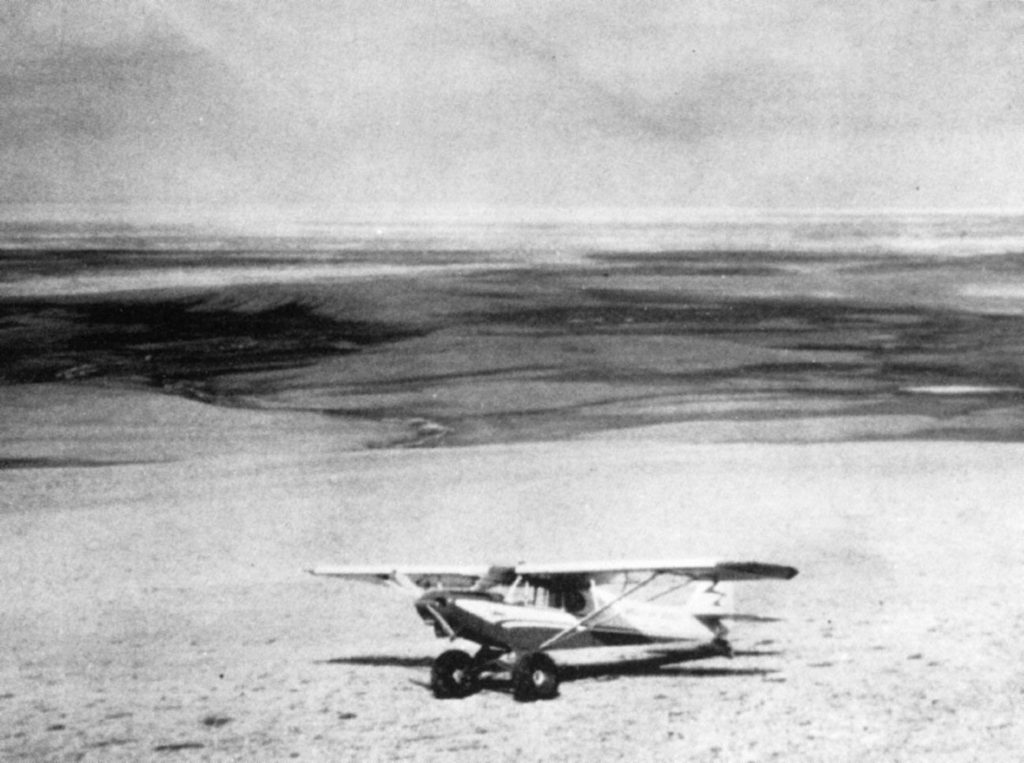 Small airplane on the ground in the Arctic summer. 