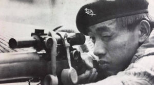 Gurkha sniper aiming his L42A1 sniper rifle.