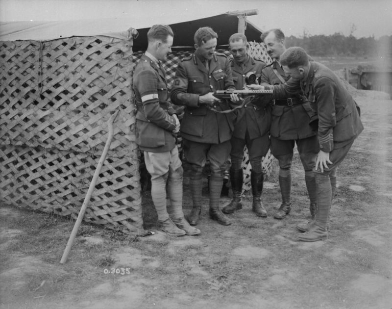 0-3035 "Brig.-General Odlum examining automatic rifle." - The weapons is actually MP-18 I sub-machine gun which fires 9 mm pistol ammunition. Battle of Amiens, France, August 1918