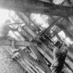 Sniper in rafter of a barn and observer lower down.