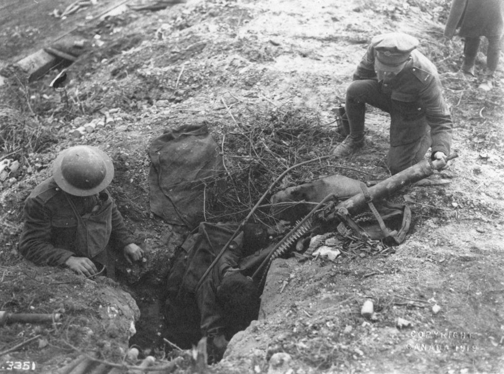 Photo O-3351 M.G. 08/ 15 On the banks of the Canal DuNord a dead German Machine Gunner, killed by advancing Canadians.