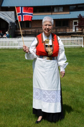 Jeanette Stevens on the right in her Norwegian bunad at a Scandinavian Centre event, in Burnaby, BC, 2016. The lady with the green apron is wearing a Swedish folk costume. Jeanette Stevens wearing her Norwegian Hardnager Bunad in 2019.
