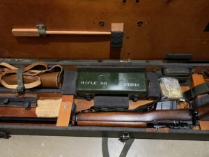 L42A1 - Centre section in transit chest. Showing 1955 dated No. 8 MK. I scope case (mismatched) NOS scope case strap in packaging, cleaning kit stowed, rifle and sling, chamber cleaning stick.