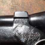 L42A1 Scope bracket showing rifle serial number on. Bracket made by Rose Brothers ("JG" mark) in England in WWII. Previous rifle serial number that it was assigned to has been proterly cancelled and new serial number (without letter prefix) added.