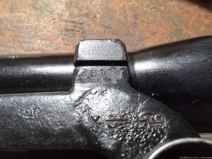L42A1 Scope bracket showing rifle serial number on. Bracket made by Rose Brothers ("JG" mark) in England in WWII. Previous rifle serial number that it was assigned to has been proterly cancelled and new serial number (without letter prefix) added.